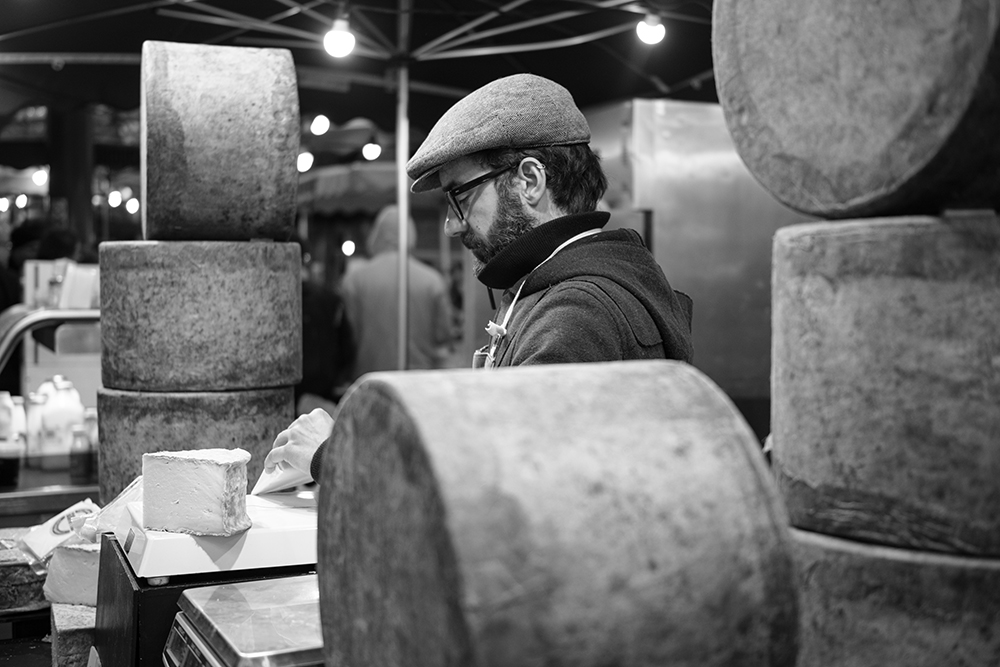 cheese market stall black and white photo taken with full-frame mirrorless
