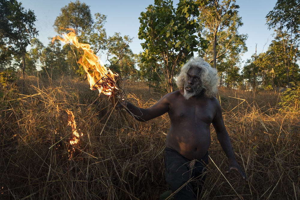 Nawarddeken elder Conrad Maralngurra burns grass to protect the Mamadawerre community from late-season ‘wildfires’, in Mamadawerre, Arnhem Land, Australia, on 3 May 2021. The late-evening fire will die out naturally once the temperature drops and moisture levels rise