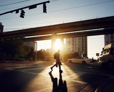 Man crossing road at sunset in Miami, Credit: Ezra Bailey, Getty Images