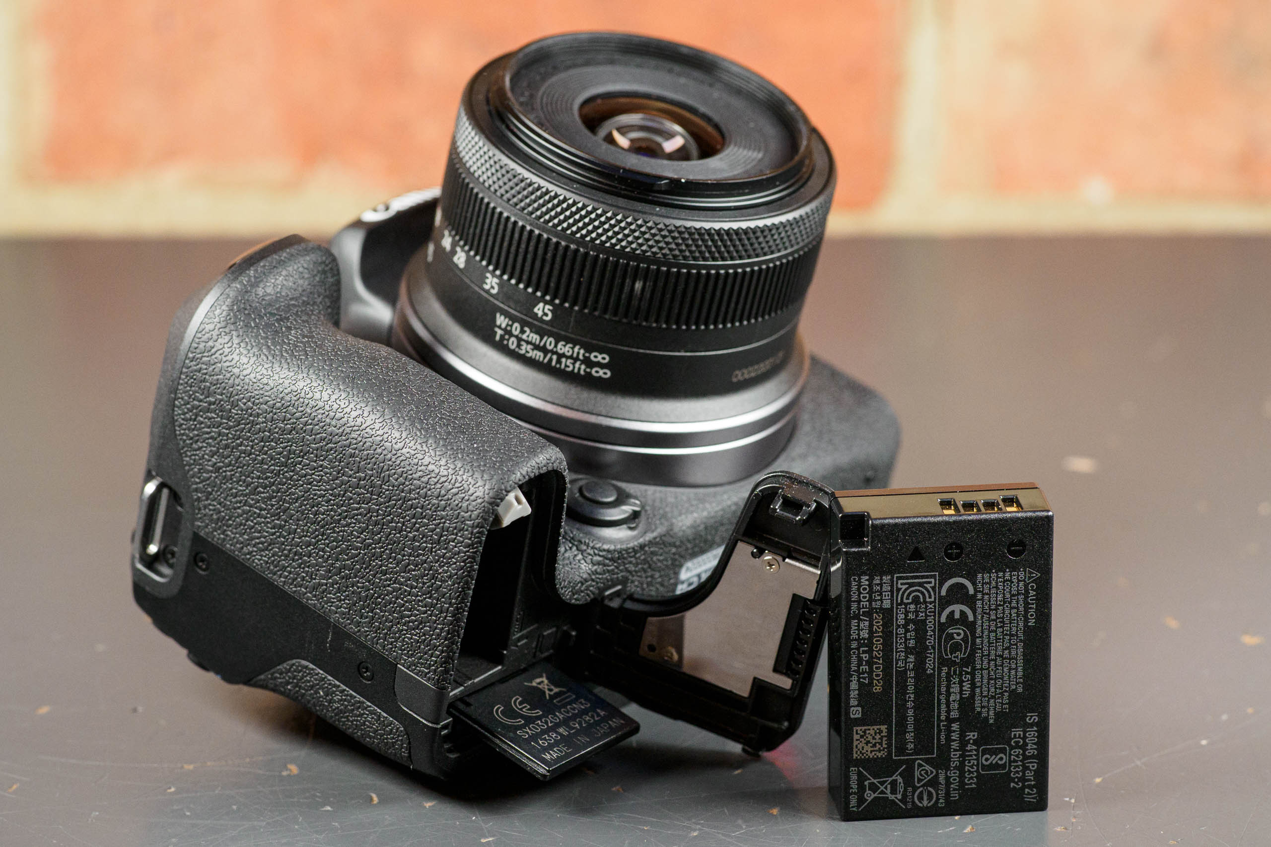 Canon EOS R10 LP-E17 battery door open, and battery