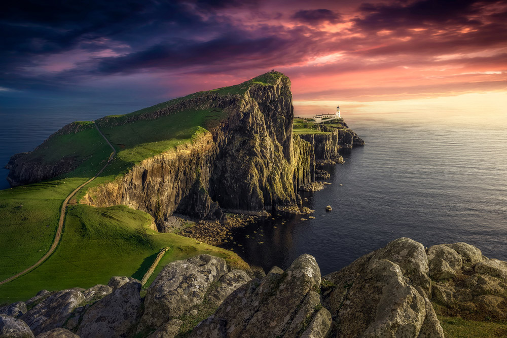 Neist Point Lighthouse, Isle of Skye, Glendale - June 9, 2019: The last sunbeam at Neist Point Lighthouse. Credit: Juan Maria Coy Vergara, Getty Images - Following the coastline your eye ends on the lighthouse.