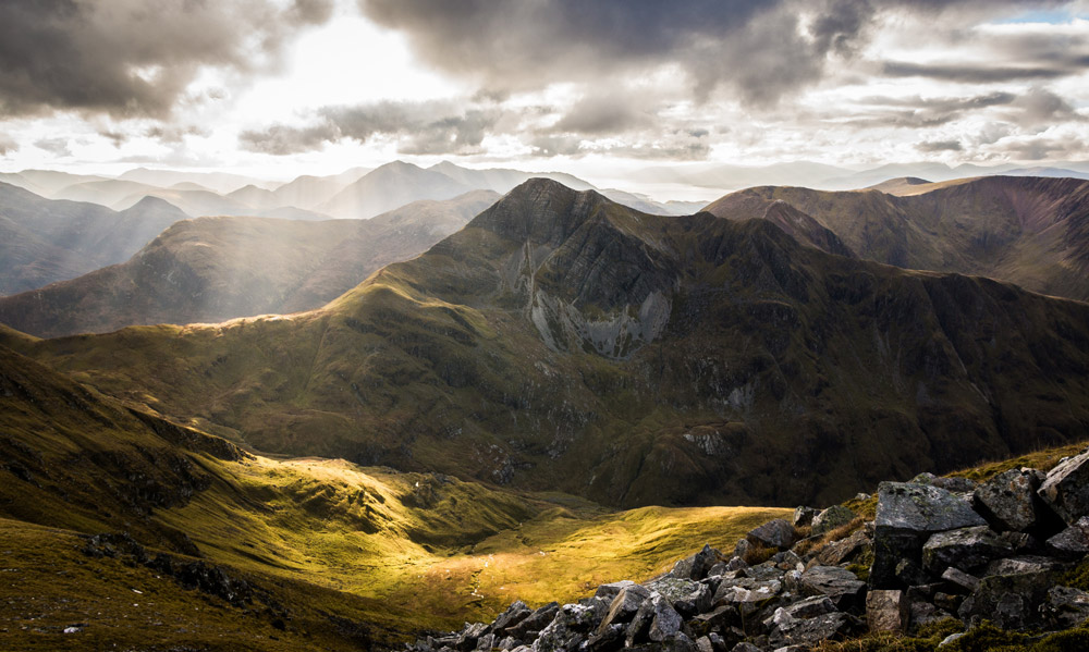 Stob Ban in Glen Nevis Landscape taken from Sgurr a'Mhaim with mid Autumn sun illuminating the glen below with layers of Glencoe mountains in the background. Credit: Scott Robertson, Getty Images