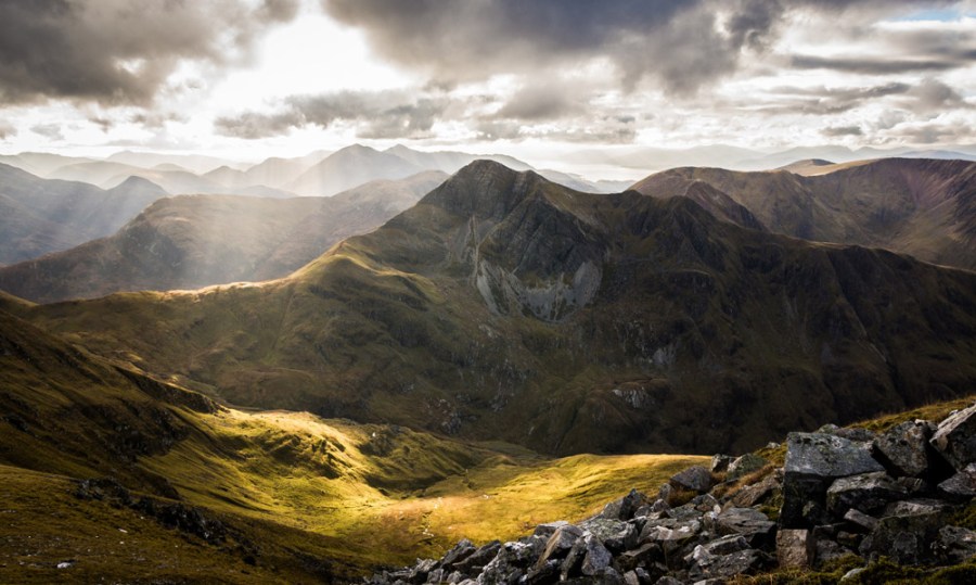 Stob Ban in Glen Nevis taken from Sgurr a'Mhaim with mid Autumn sun illuminating the glen below with layers of Glencoe mountains in the background. Credit: Scott Robertson, Getty Images