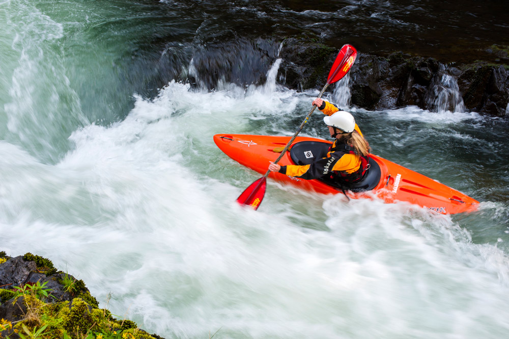 A female kayaker paddling on the White Salmon River in Washington State. Credit: Charlie Munsey, Getty Images
