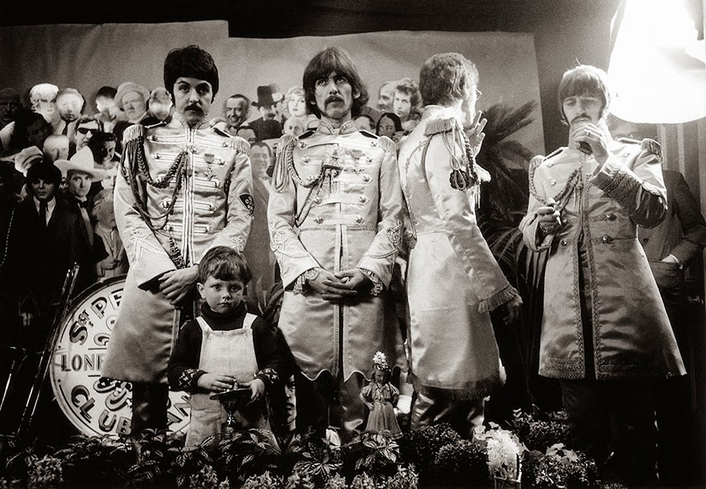 The Beatles pictured in their Sgt. Pepper’s satin band uniforms with Michael Cooper’s son, Adam. Sgt. Pepper's Lonely Hearts Club Band album
