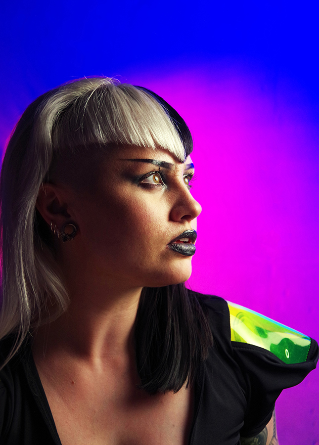 Model Meg Biffen @meg_biffin, was lit using an AEOS 2 in an R90 Parabolic softbox as the key light. The wall was lit by two AEOS 2 lights, one set to a blue gel and the other to magenta. sci-fi event