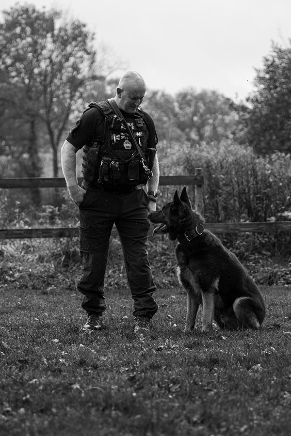 black and white policeman with dog
