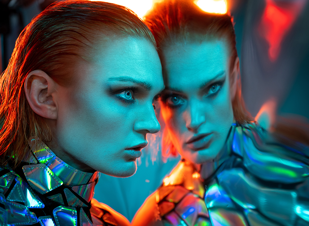 A hanging sheet of highly reflective mylar film provided the distorted reflection for model Katie Willy @katie.t.willy in this shot. The key light was an AEOS 2 with the dome diffuser, set to a cyan colour, while a second AEOS set to orange lit her from behind.rotolight sci-fi event