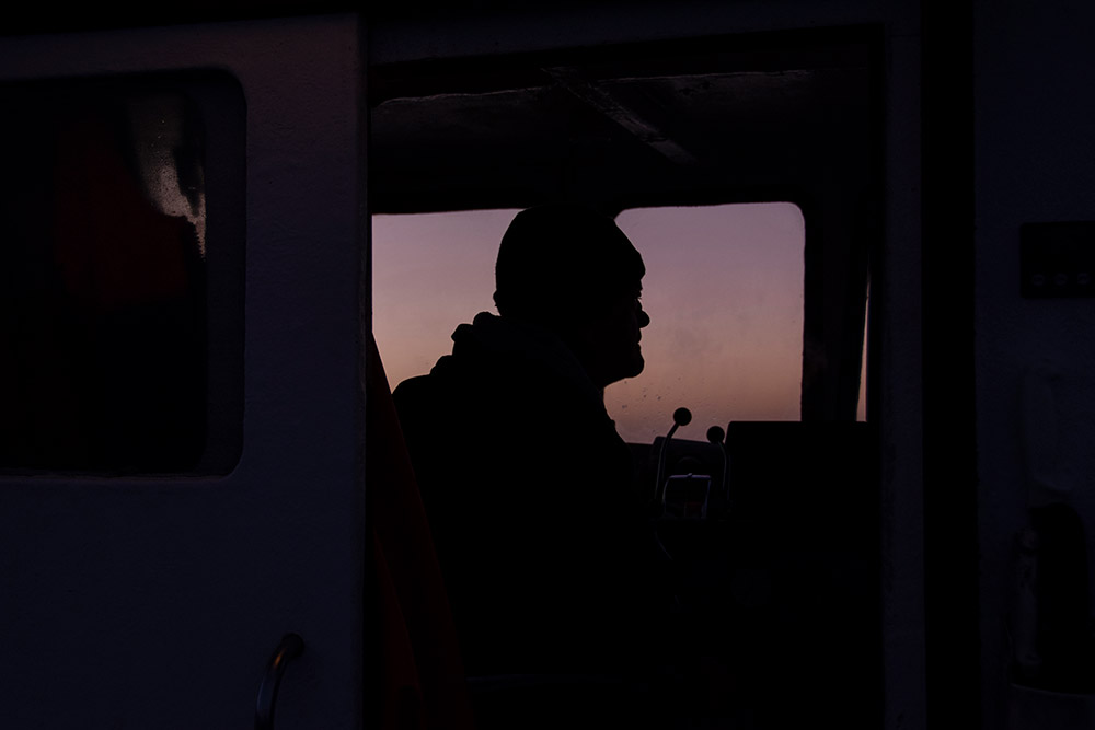 silhouette fisherman in boat