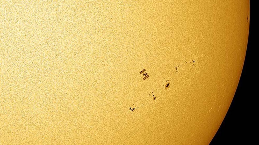 The ISS passing in front of the Sun with sun spots visible. © Jamie Cooper Photography