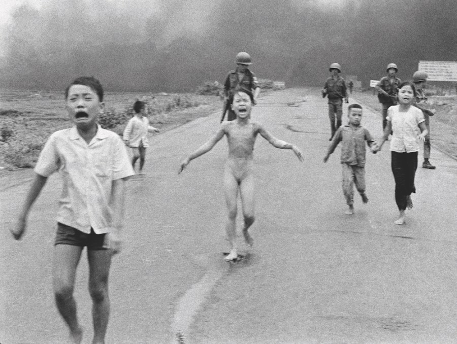 South Vietnamese forces follow behind terrified children, including 9-year-old Kim Phuc, centre, as they run down Route 1 near Trang Bang after an aerial napalm attack on suspected Viet Cong hiding places. The Terror of War, aka Napalm Girl. © Nick Ut/AP/Shutterstock