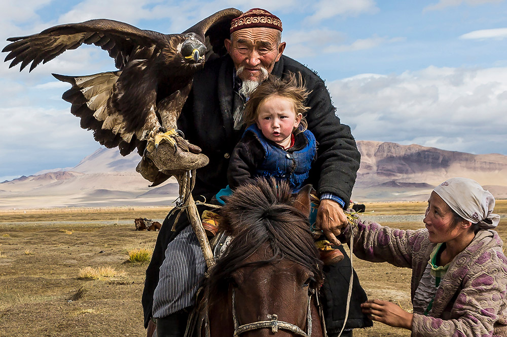 A woman makes sure that her child, the eagle hunter’s grandson, is safely secure. Hunting with eagles is practiced by a handful of Kyrgyz and Kazakhs in the Altai Mountains. Image: Tariq Zaidi career