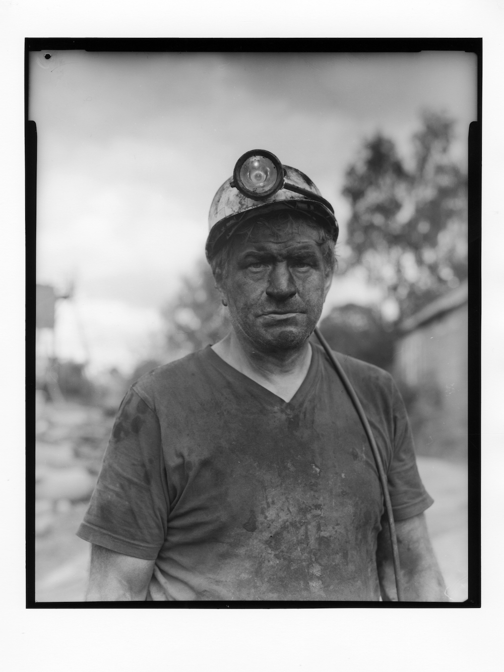 Babe, one of the last Yorkshire miners, 2010. Ian Beesley explains, 'I spent years photographing Hayroyd’s Pit in Clayton West, Yorkshire. Babe was a face worker. He asked me to take a formal portrait with my plate camera after he had finished his shift and was still covered in pit dirt. He wanted the photograph for his grandchildren and their children. 'We are the last of the miners and soon we will all be gone, I want my grandkids, their kids and their grandkids to know I was a miner and this is what I looked like.' © Ian Beesley
