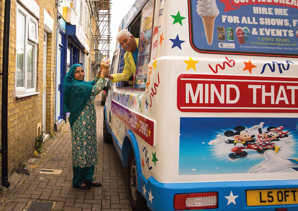 Former ice cream seller Genesio Borrillo pictured serving Zahida Parveen at a borrowed ice cream van, May 2021. Borrillo now runs a pasta shop in Peterborough with his family. © Chris Porsz