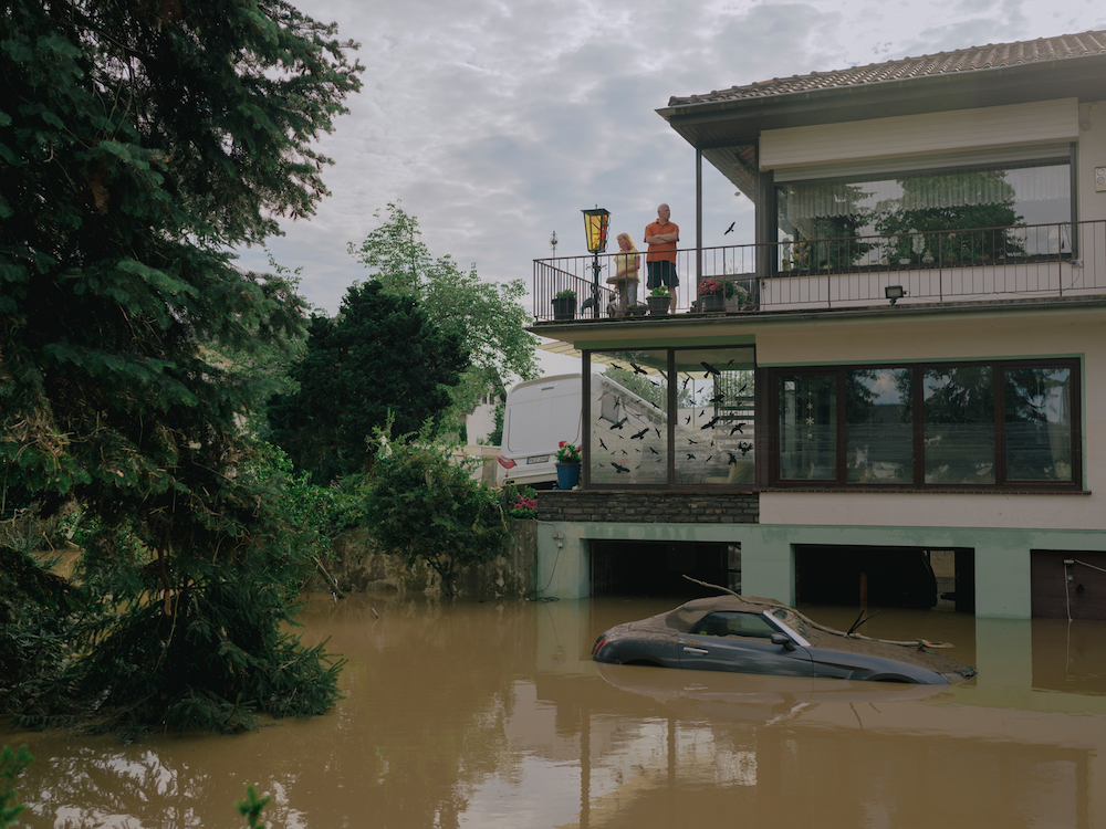 People on the balcony of a house in Ahrweiler, Germany on 15 July 2021. On the first day after the flood, the extent of the destruction was difficult to assess, so there was a catastrophic shortage of equipment and emergency personnel in the flooded area. © DOCKS Collective/LOBA 2022