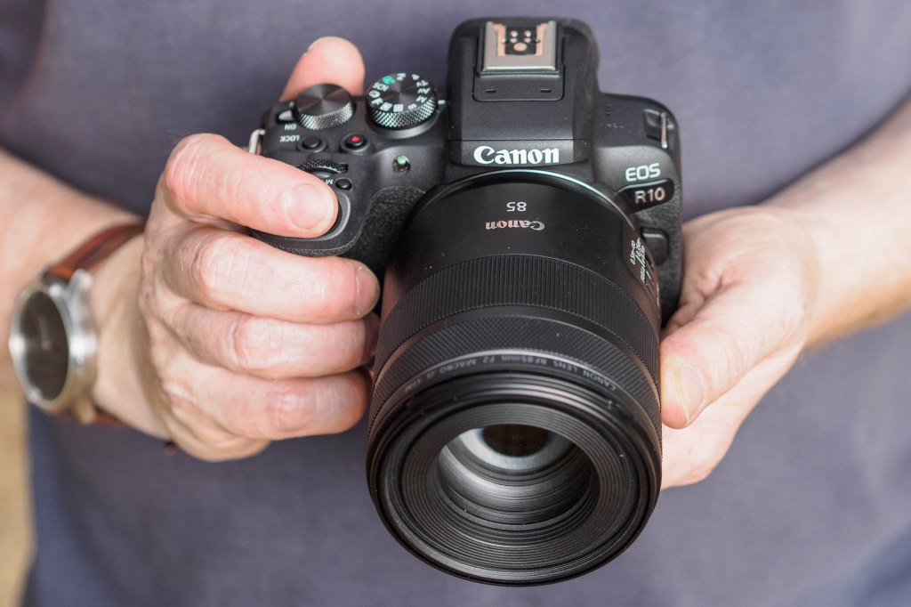 Canon EOS R10 in hand with RF-S 85mm lens