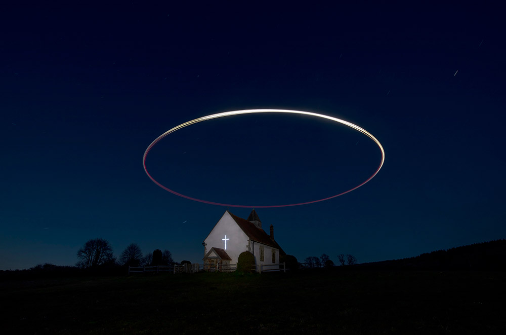drone light ring made over a church in night scene