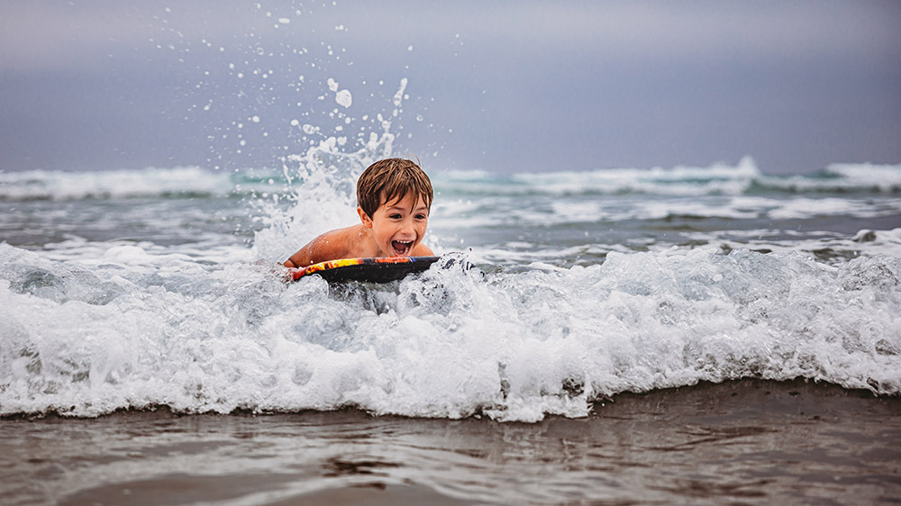 children playing in waves