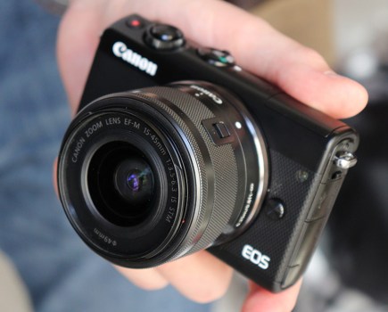 Canon EOS M100 in hand, image AP