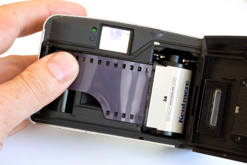 Loading a 35mm film into a point and shoot film camera, photo: Joshua Waller