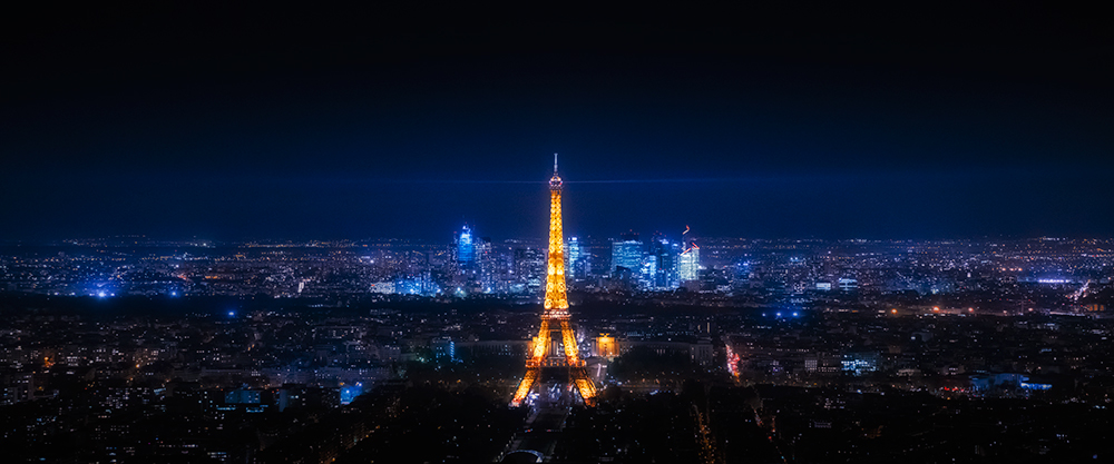 looking at eiffel tower at night lit up liam wong