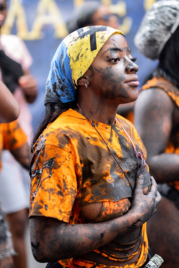 woman covered in paint of streets of notting hill carnival