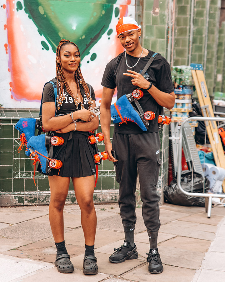 two people at notting hill carnival with roller skates around their neck Image: Elizabeth Okoh ukbftog
