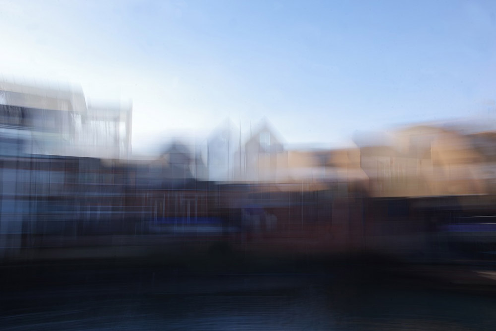 intentional camera movement image of buildings by a sea harbour fine art photography