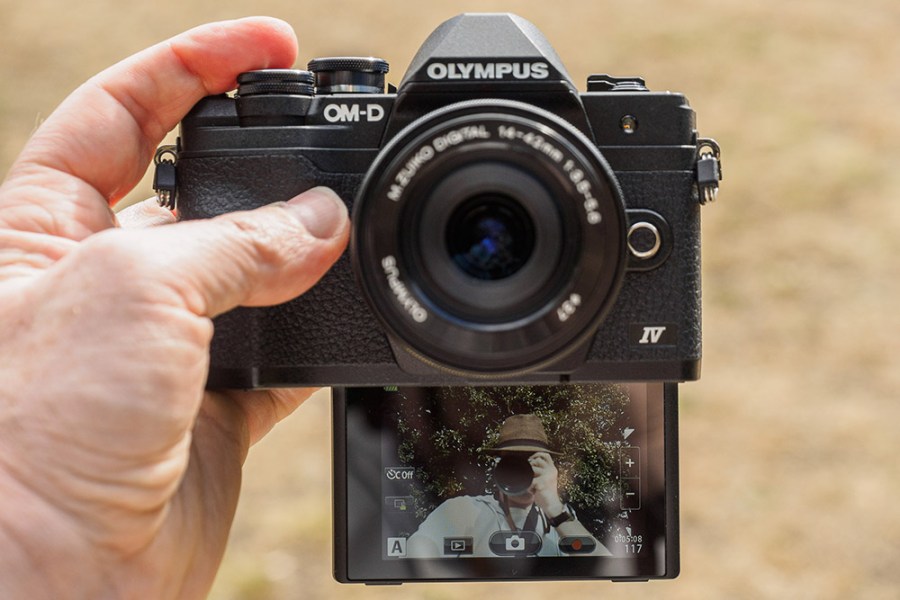 Olympus OM-D E-M10 Mark IV in hand, with selfie screen