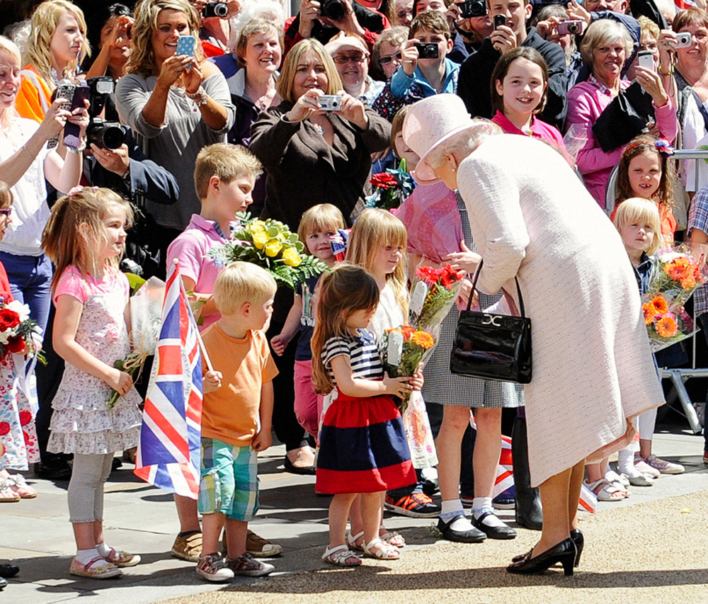 The Queen visits Worcester with The Duke Of Edinburgh and is greeted by children bearing flowers, 2012. © James Watkins.
