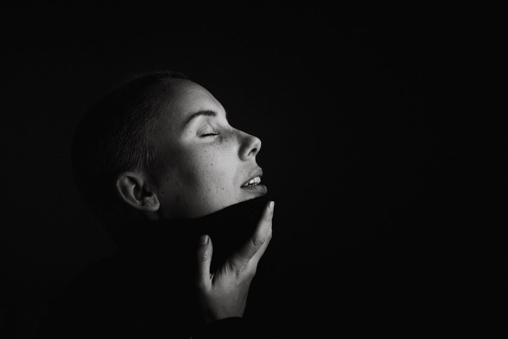 Low light portrait of woman in black and white