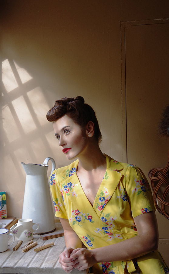 1940s kitchen scene with model looking out of the window