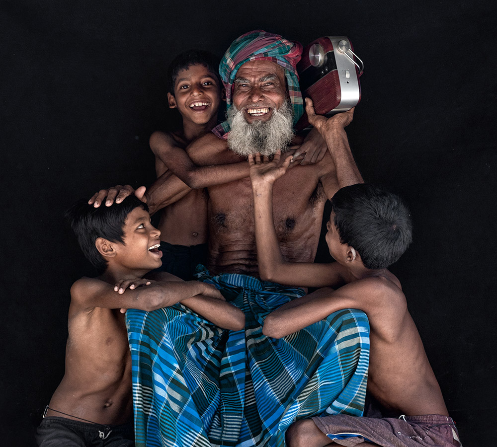 Happy Mukherjee portrait of happy children with grandfather 