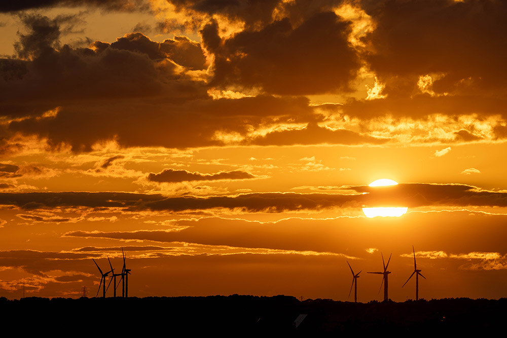 sunset with turbines on the horizon manual focus