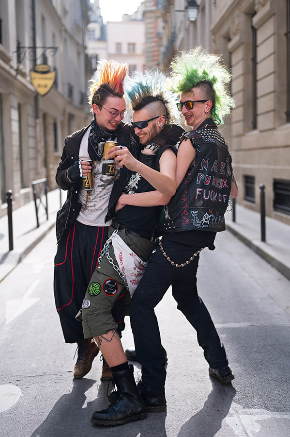 three punks pose together in a suburban street 