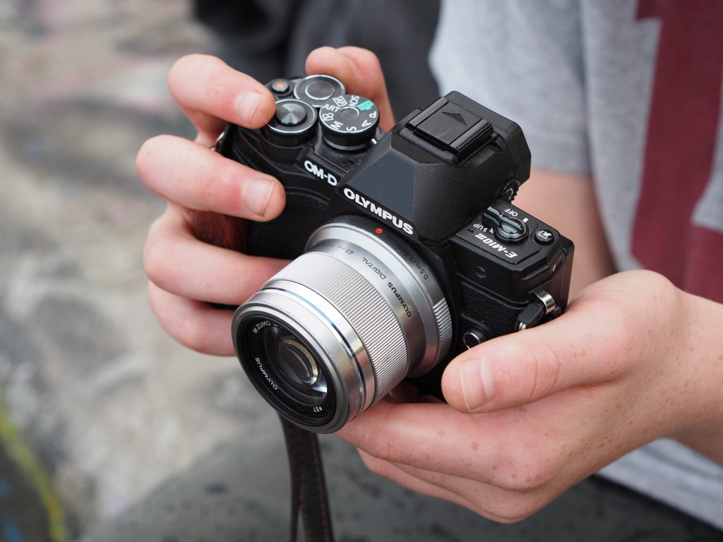 The Olympus OM-D E-M10 Mark III with 45mm lens in hand. Photo: Joshua Waller