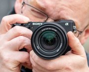 Sony Alpha A6400 in hand, with 18-135mm lens, Andy Westlake