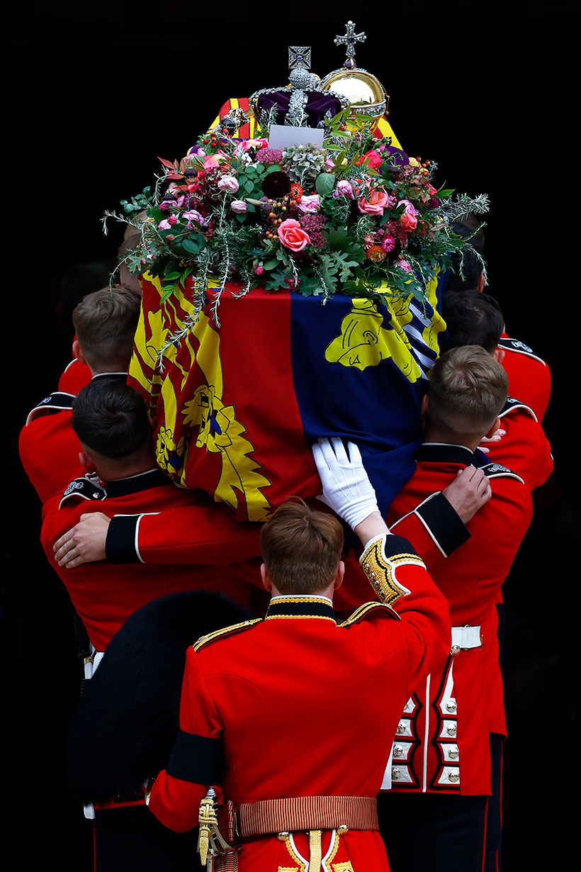Pallbearers carry the coffin of Queen Elizabeth II with the Imperial State Crown resting on top into St. George's Chapel on September 19, 2022 in Windsor, England by Jeff J Mitchell/Getty Images
