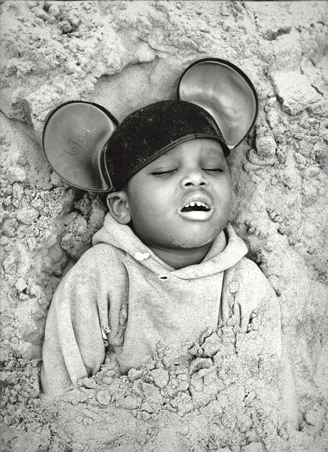 Arthur Tress, Child Buried in Sand, Coney Island, 1968, gelatin silver print. © 2018 Arthur Tress Legacy Trust