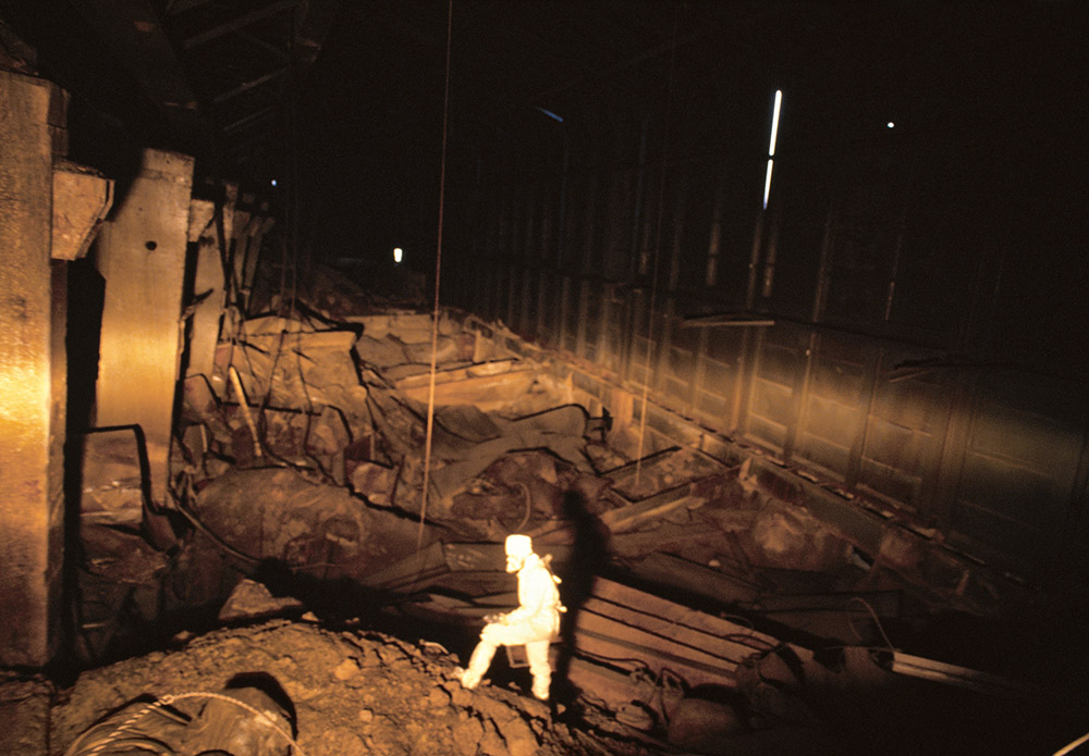 Victoria Ivleva, Dosimetrist Yuri Kobsar climbs radioactive debris inside the fourth reactor at Chernobyl nuclear power plant, 1991. © Victoria Ivleva best women photographers alternate history