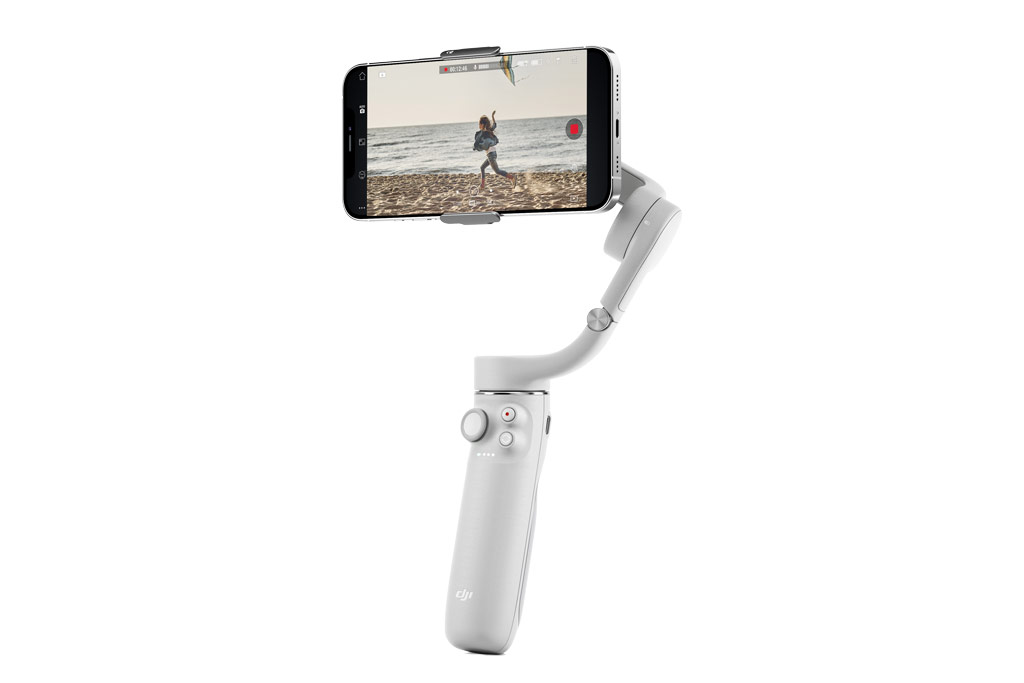 Best camera phone tripods and mounts DJI OM 5 Gimbal / Selfie stick with smartphone in between clamps against a white background