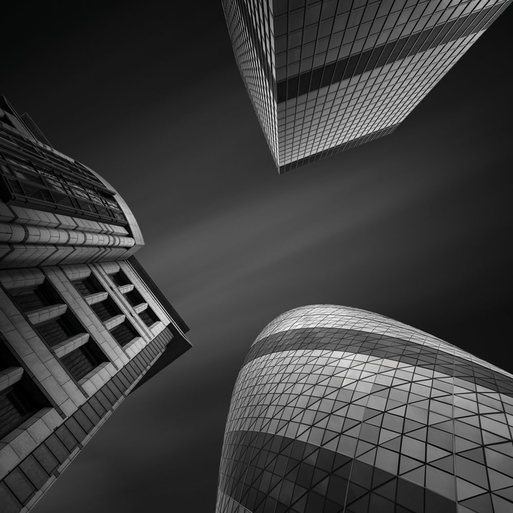 Black and white building photography, Billy Currie. Looking up, The Gherkin and two nearby buildings.