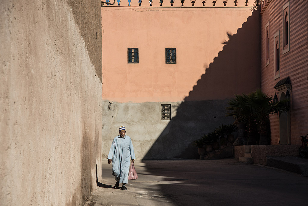 man walking with shopping in marrakech street, best cities for photography