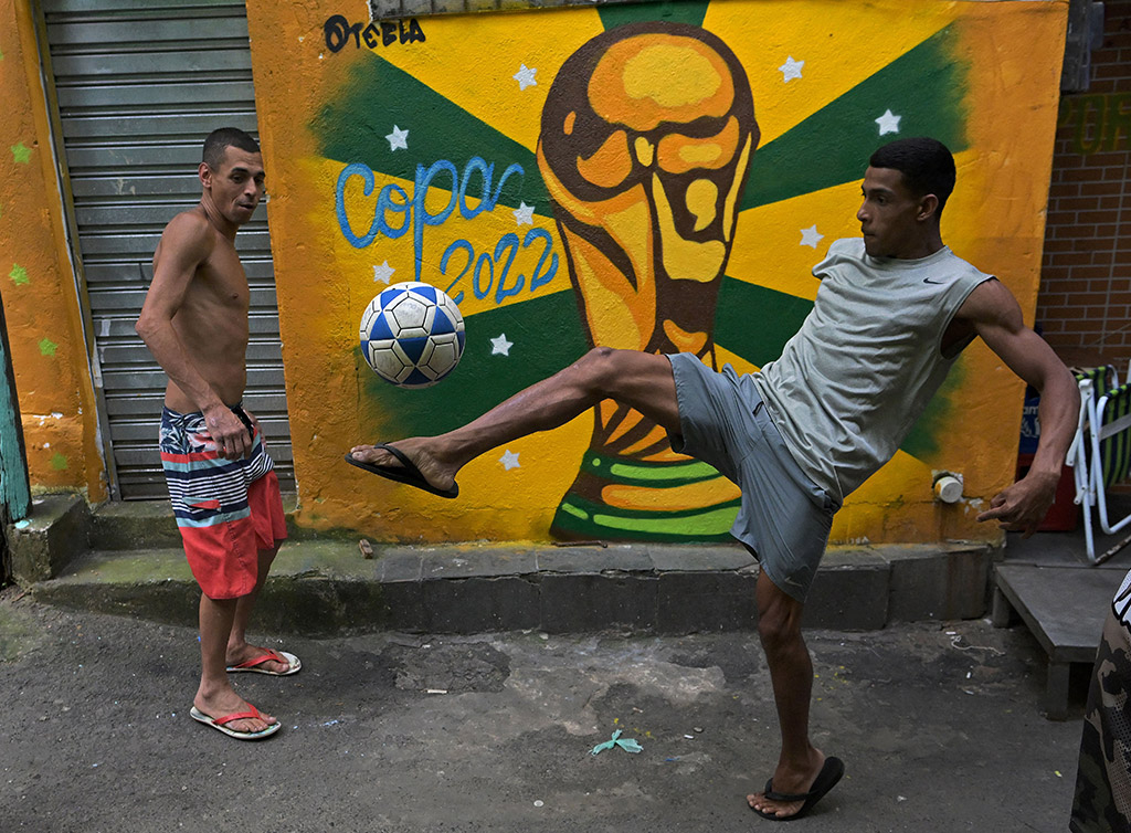 two men playing with football in Rio de Janeiro street