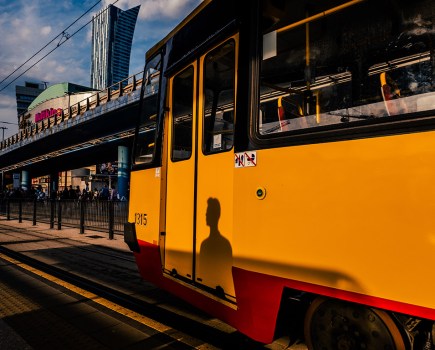 person shadow against yellow train street photos stand out