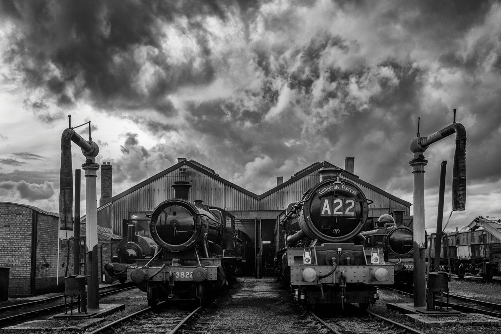 Black and white photo of two trains