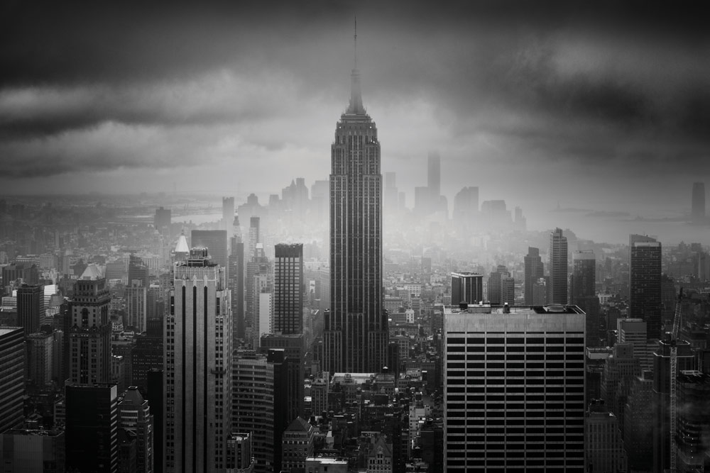 Black and white capture of the Empire State Building on a cloudy misty day. photography, Billy Currie