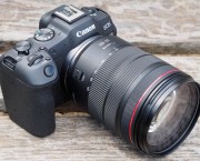 Photograph of Canon EOS R8 on wooden surface with lens attached