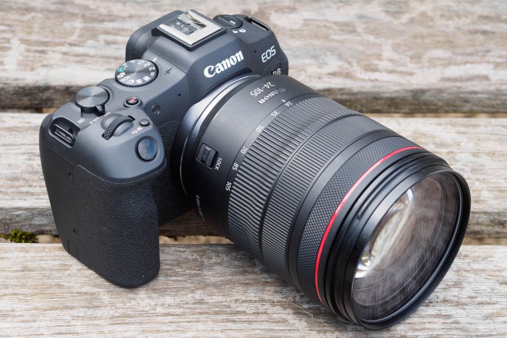 Photograph of Canon EOS R8 on wooden surface with lens attached