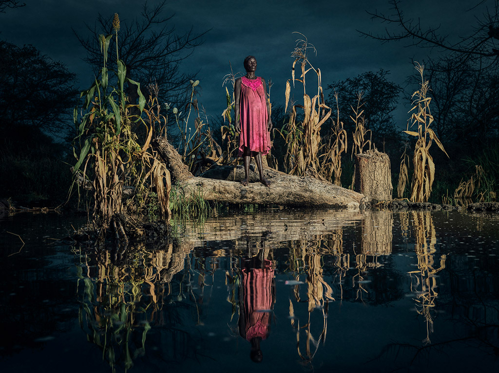 Nyadiang Gak, 50, from Lakabang Village, stands beside her destroyed maize crops after losing – for two years in a row – her much-needed harvest.